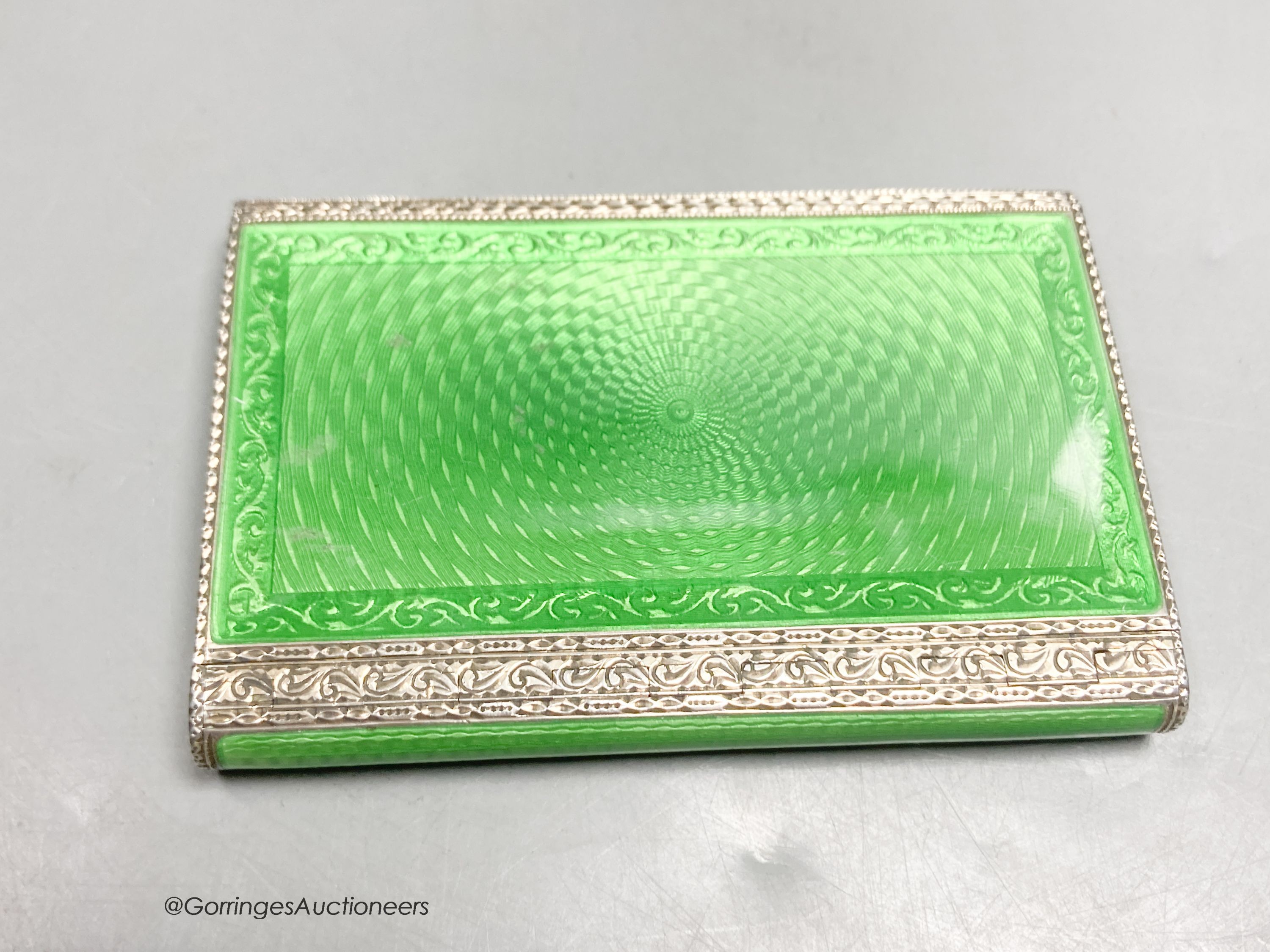 A 1920's continental silver and green guilloche enamel rectangular box and hinged cover, import marks for Cohen & Charles, London, 1927, 79mm by 54mm by 10mm